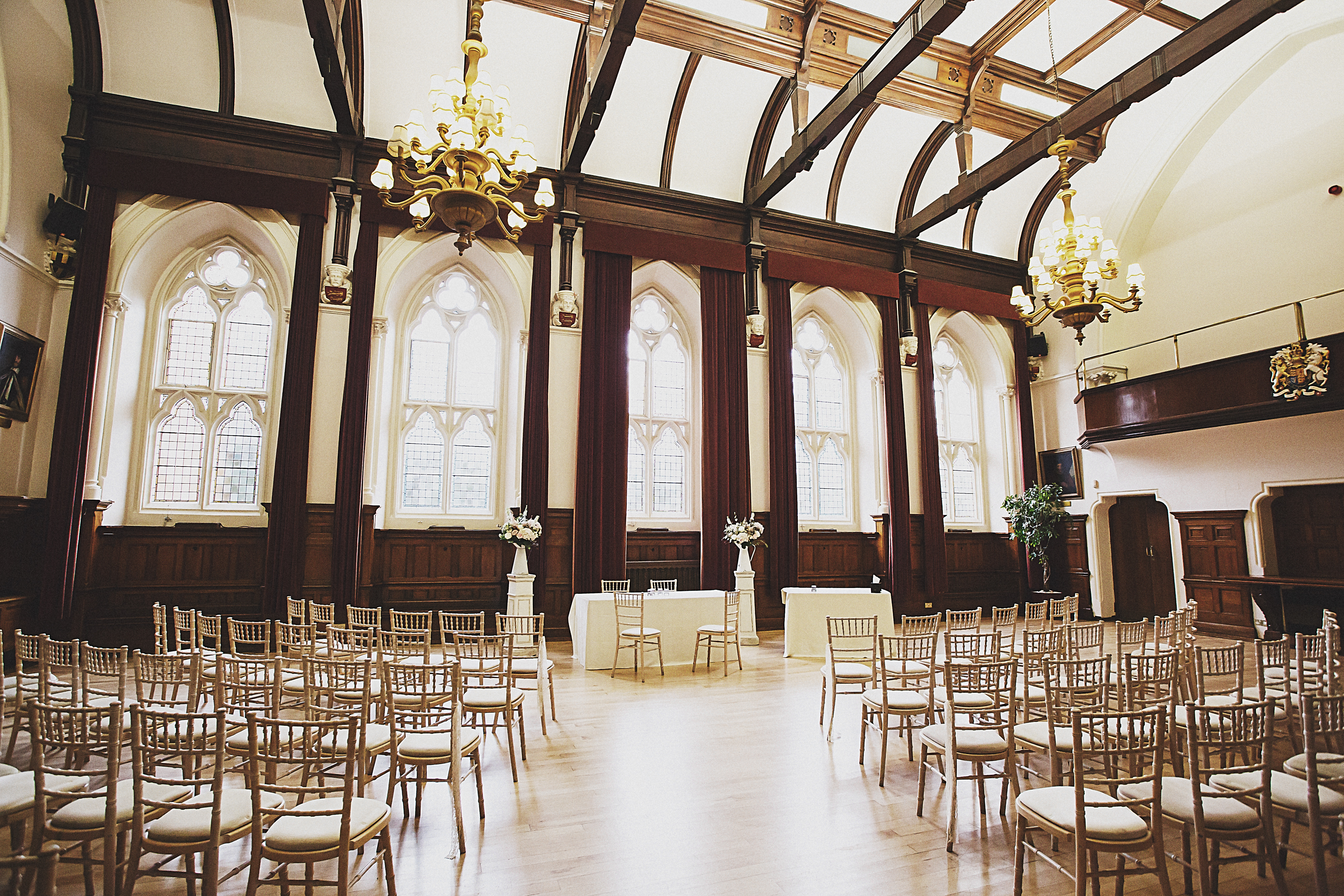 A wedding ceremony in the King Charles Hall facing the windows